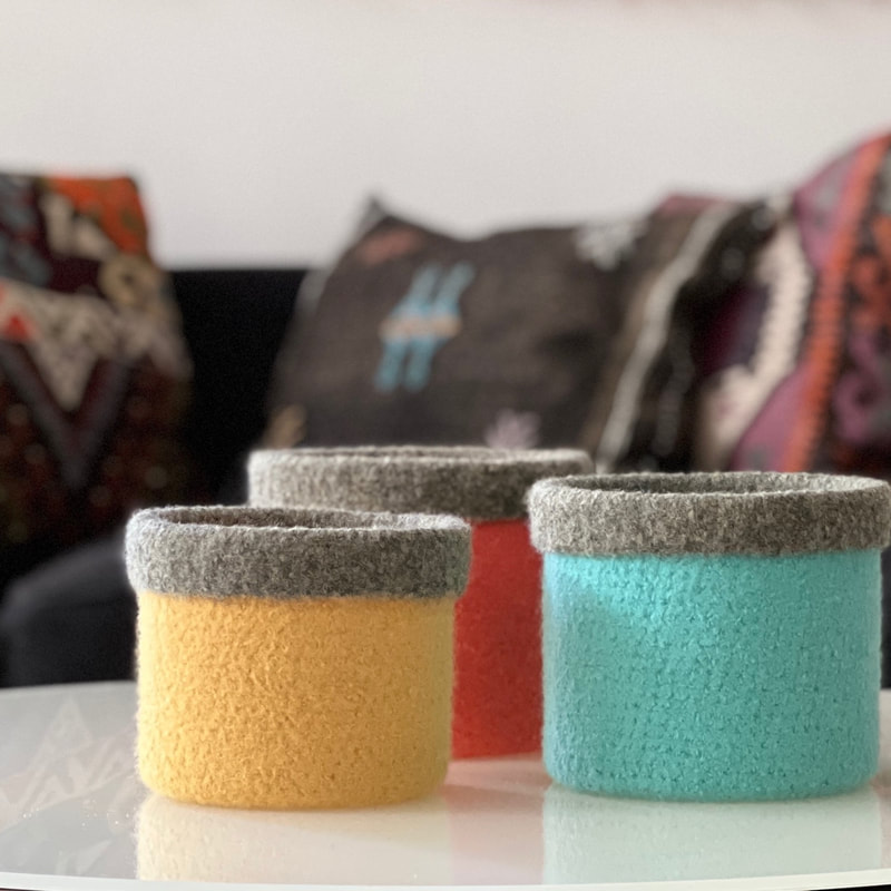 CUFF are straight sided felted vesseld with a fold down top in various sizes and colours