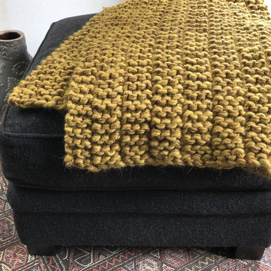 CLIFTON is a hand knit big-wool throw made with  grainy mustard colored Peruvian highland wool by zed handmade