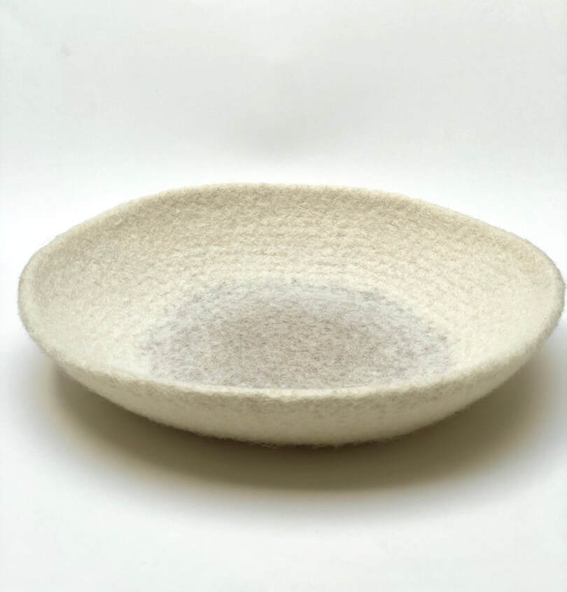 ORB is a large hand-felted bowl in cream and putty colors