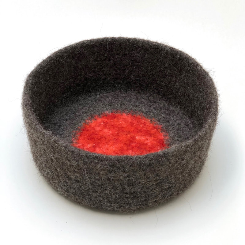 ORB is a large hand-felted cylindrical bowl in gunmetal and zinnia
