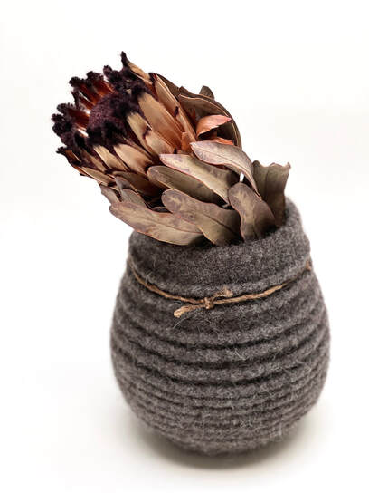 BOLA Ridged is a textured felted vessel in undyed gunmetal wool with Tussah silk 