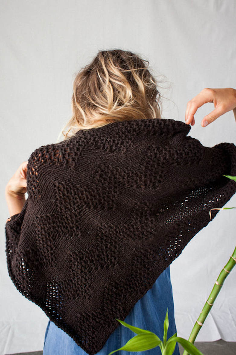 LUCE Warmer hand knit highly textural small poncho in ebony